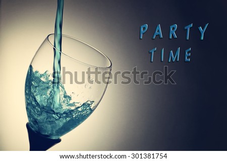 Blue water splash in glass with Party Time text