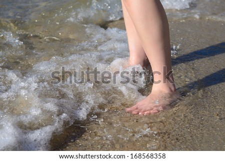 Female feet in water