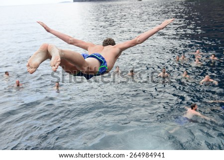 young man jumping in the water