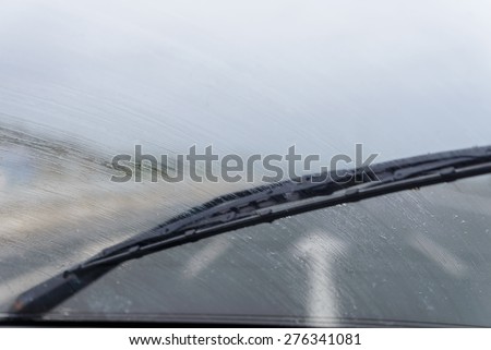 wipers on the windshield of the car in the rain