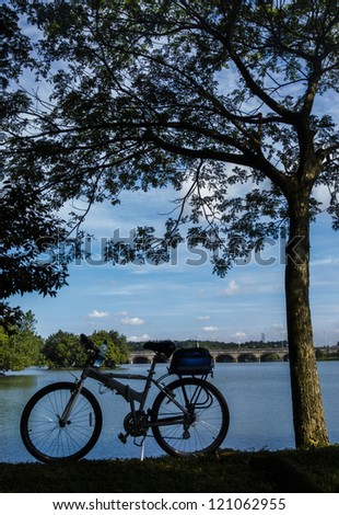 Silhouette of a touring bicycle by a lake