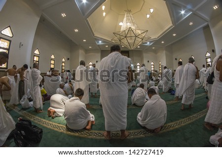 MECCA - FEB 21 : Muslim pilgrims in \'ihram\' clothes pray at one of the mosques Feb 21, 2012 in Mecca. \'Ihram\' clothes consist of two unhemmed white clothes intended to make everyone appear the same.