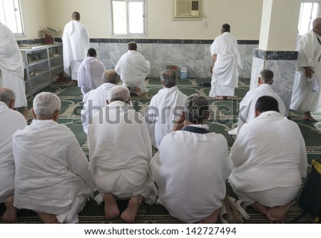 MECCA - FEB 22 : Muslim pilgrims in \'ihram\' clothes pray at one of the mosques Feb 22, 2012 in Mecca. \'Ihram\' clothes consist of two unhemmed white clothes intended to make everyone appear the same.