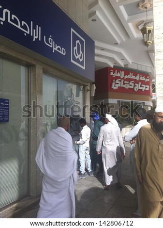 MECCA, SAUDI ARABIA - JUNE 3 : Customers of Al Rajhi bank withdraw money from ATM on June 3, 2013 in Makkah. Al Rajhi Bank is worldÃ?ÃÂ¢??s largest Islamic bank with 600 branches in Saudi region.