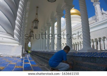 Man takes ablution at Masjid Sultan Omar Ali Saifuddin Mosque in Bandar Seri Begawan, Brunei Darussalam. Brunei plan to implement sharia law soon.