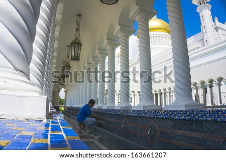 Man takes ablution at Masjid Sultan Omar Ali Saifuddin Mosque in Bandar Seri Begawan, Brunei Darussalam. Brunei plan to implement sharia law soon.
