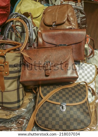 BANDUNG, WEST JAVA ISLAND, INDONESIA - SEPTEMBER 16, 2014: Large collection of famous fake handbags on display at one of the shopping centres in Bandung. The fake handbags are widely sold cheaply here.