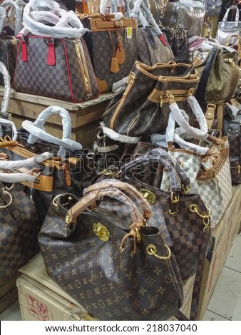 BANDUNG, WEST JAVA ISLAND, INDONESIA -SEPTEMBER 16, 2014: Large collection of famous fake handbags on display at one of the shopping centres in Bandung. The fake handbags are widely sold cheaply here.