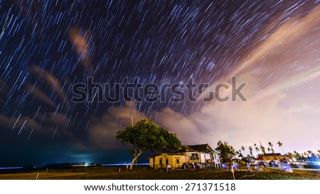 Stacked of images of milky way and stars produced colorful star trails in Kuala Terengganu, Malaysia. Isolated house in the foreground