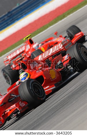 Extreme angle of Felipe Massa leading his team mate Kimi Raikkonen at a turn at Sepang F1 Malaysia 2007 Grand Prix