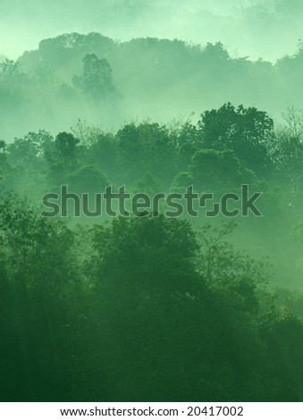 Misty hilly area with ray of light.