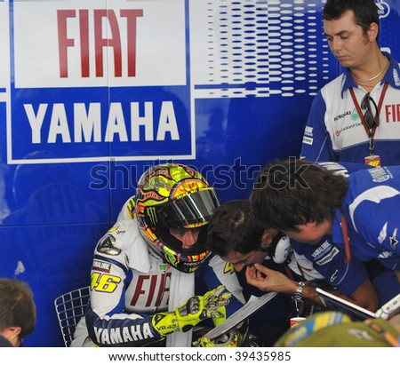 SEPANG, MALAYSIA - OCT 23 : Italian Valentino Rossi of Fiat Yamaha Team talks to his mechanics after a testing session at Shell Advance Malaysian Motorcycle Grand Prix held October 23, 2009 in Sepang, Malaysia.
