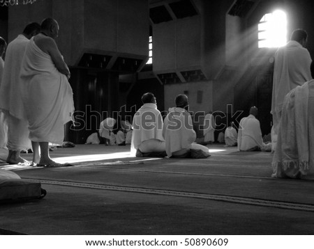 MECCA - DEC 11 : Muslim pilgrims in \'ihram\' clothes pray at one of the mosques Dec 11, 2007 in Mecca. \'Ihram\' clothes consist of two unhemmed white clothes intended to make everyone appear the same.