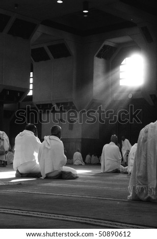 MECCA - DEC 11 : Muslim pilgrims in \'ihram\' clothes pray at one of the mosques Dec 11, 2007 in Mecca. \'Ihram\' clothes consist of two unhemmed white clothes intended to make everyone appear the same.