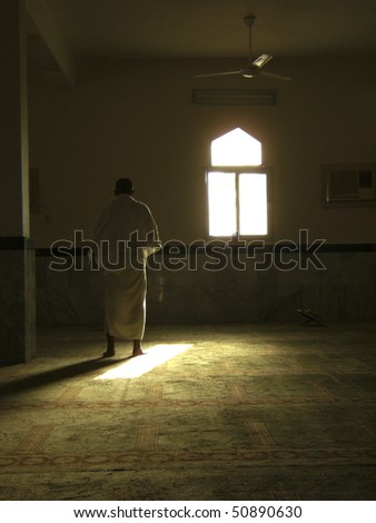 MECCA - JAN 3 : A Muslim pilgrim in \'ihram\' clothes prays in one of the mosques Jan 3, 2008 in Mecca. \'Ihram\' clothes consist of two unhemmed white clothes intended to make everyone appear the same.