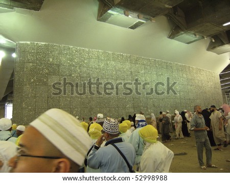 MINA - DEC 22:Muslim pilgrims perform \'stoning of the devil\' ritual at one of the wall pillars (jamrah) Dec 22, 2007 in Mina, Saudi Arabia. Stoning of devil is one of the rituals to complete the hajj.
