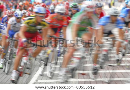 Motion blur of a group of cyclists in action during a cycling tour.