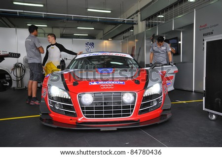 SEPANG, MALAYSIA-SEPT 16:Mechanics inspect Audi R8 LTS car of Pauian Archibald Absolute Racing team at GT Class qualifying Malaysia Merdeka Endurance Race (MMER) 2011 in Sepang on Sept. 16, 2011