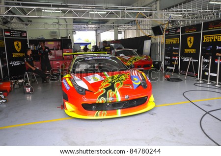stock photo SEPANG MALAYSIASEPT 16Mechanics inspect Ferrari F458 car of