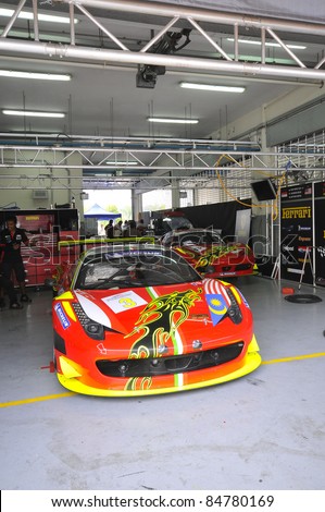 SEPANG, MALAYSIA-SEPT 16:Mechanics inspect Ferrari F458 car of Clearwater Racing team of Singapore at GT Class qualifying Malaysia Merdeka Endurance Race (MMER) 2011 in Sepang on Sept. 16, 2011