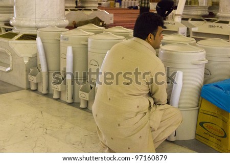 AL MADINAH, SAUDI ARABIA-FEB. 17: An unidentified man drinks zam zam water inside Masjid Nabawi on February 17, 2012 in Al Madinah, S. Arabia. Zamzam water are freely and available in abundant here.