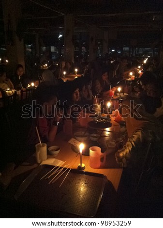 KUALA LUMPUR,MALAYSIA-MARCH 31:Unidentified Malaysian families experience Earth Hour 2012 while having satay dinner in K. Lumpur on Mar 31 2012.The event is held annually on the last Saturday of March