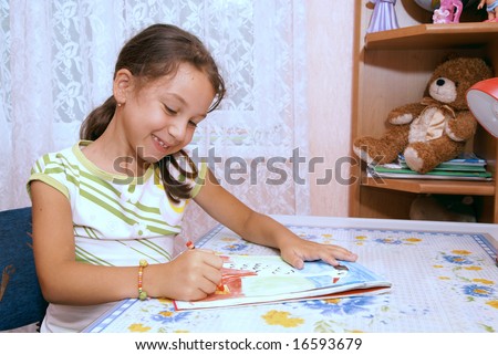 School girl draws in album