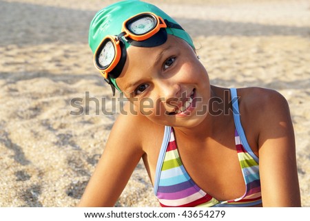 stock photo Preteen girl in diving outfit enjoying sunbath on sea beach