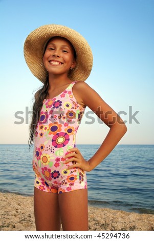 stock photo Preteen girl in straw hat enjoying sunbath on sea beach