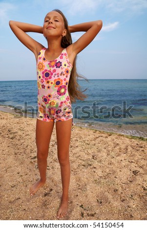 stock photo Portrait of cheerful preteen girl enjoying sunbath on sea 
