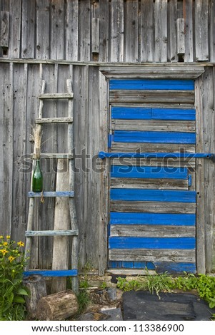 Weathered wall of old barn with a old ladder