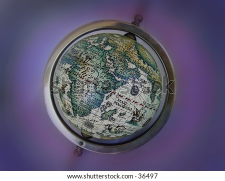An old  toy globe with symbolic ancient map. Blurred background.