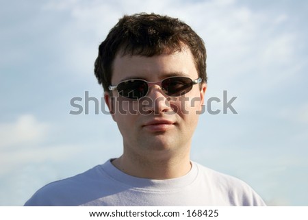 Young casual man against the sky