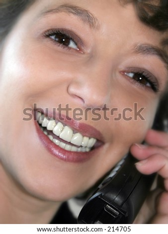 Closeup of a smiling woman talking on the phone