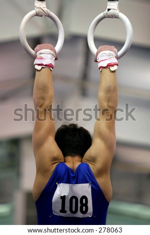 Young gymnast competing on rings