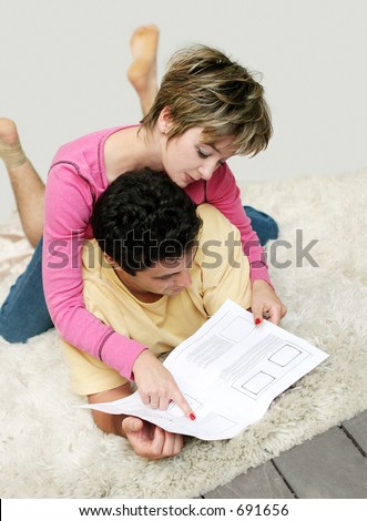 Sweet young couple reading instruction manual