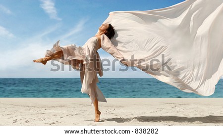 Woman with a pink scarf on the beach