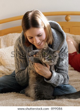 Happy girl playing with her kitten