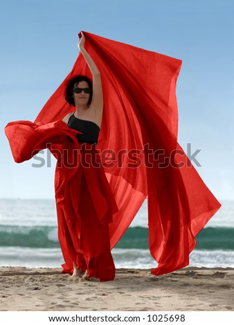 Woman on the beach with a red scarf