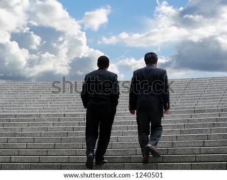 Two business men walking up the stairs