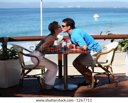 Kissing couple at a seaside cafÃ©