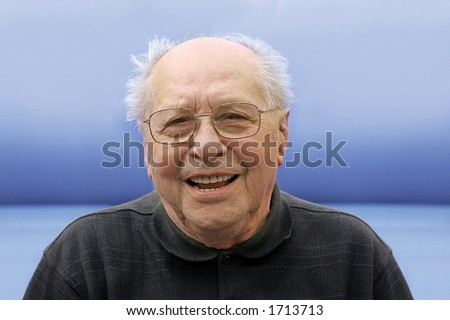 Old man laughing on a blue background