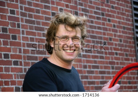 Young man against a brick wall