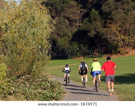 Family riding bikes in a park