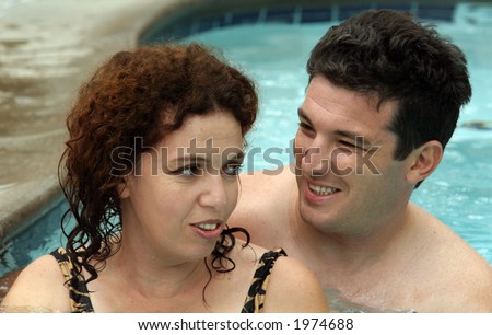 Good looking couple having good time in the pool