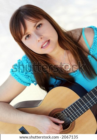 Yong pretty woman playing the guitar