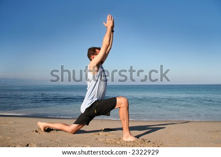 Man doing yoga exercise on the beach