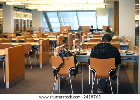 Student reading a book in the library