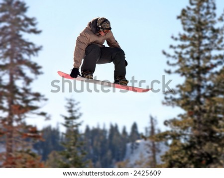Teen girl jumping high on a snowboard