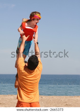 Father playing with his son on the beach
